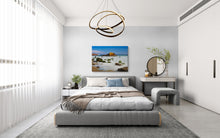 Modern bedroom with a bed, desk, and decorative elements.